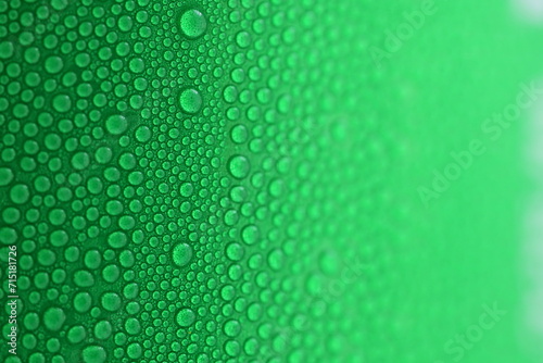water drop on green beverage cans background, texture of cold aluminium drink package photo