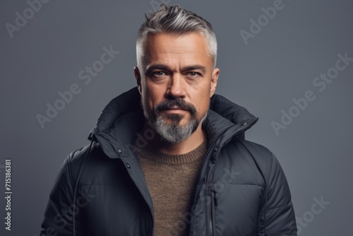 Portrait of a stylish middle-aged man with a beard and mustache wearing a black jacket. Men's beauty, fashion. © Inigo