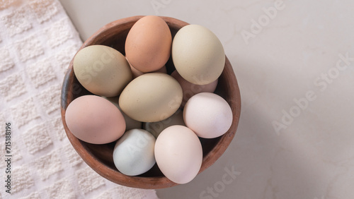 Basket of chicken eggs on the table, colorful big eggs, organic food, natural protein