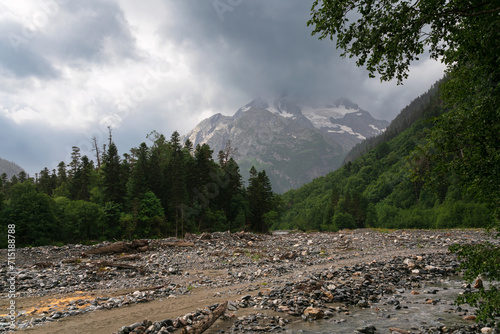 View of the Psysh River and the Amanauz-Bashi Mountain of the Northern Caucasus Mountains near the village of Arkhyz on a sunny summer day, Karachay-Cherkessia, Russia photo