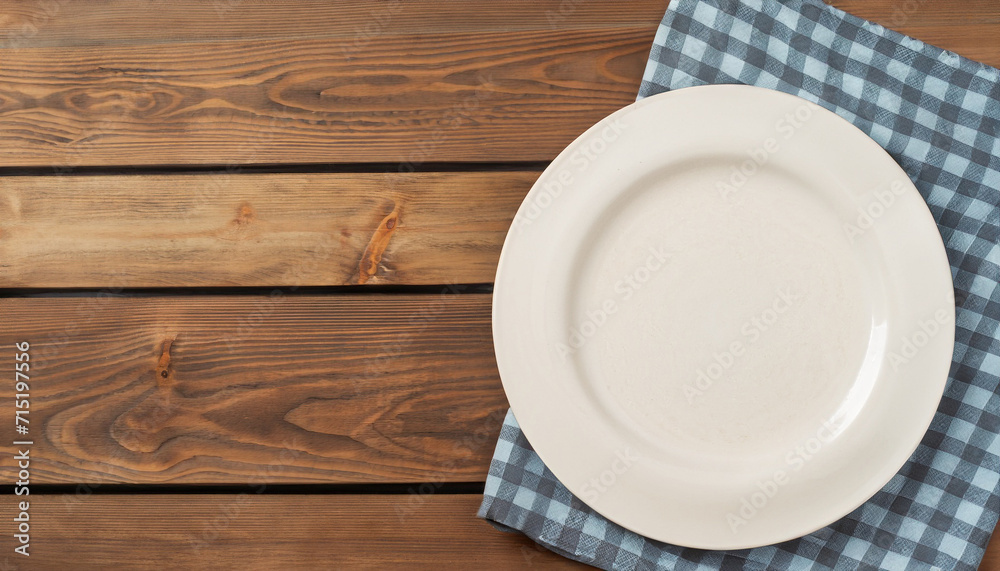 Empty plate and towel over wooden table background. View from above with copy space. high quality photo Empty plate and towel over wooden table background. View from above with copy space. high quality photo