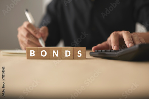 Investment funds and bonds. Plan to invest in bonds and analyze economic data. Little wooden blocks and men are planning