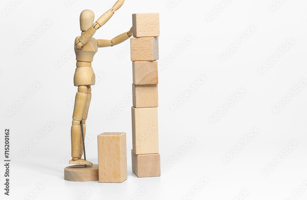 Wooden doll with wooden toy block isolated on white background. business or creative concept Wooden doll with wooden toy block isolated on white background. business or creative concept