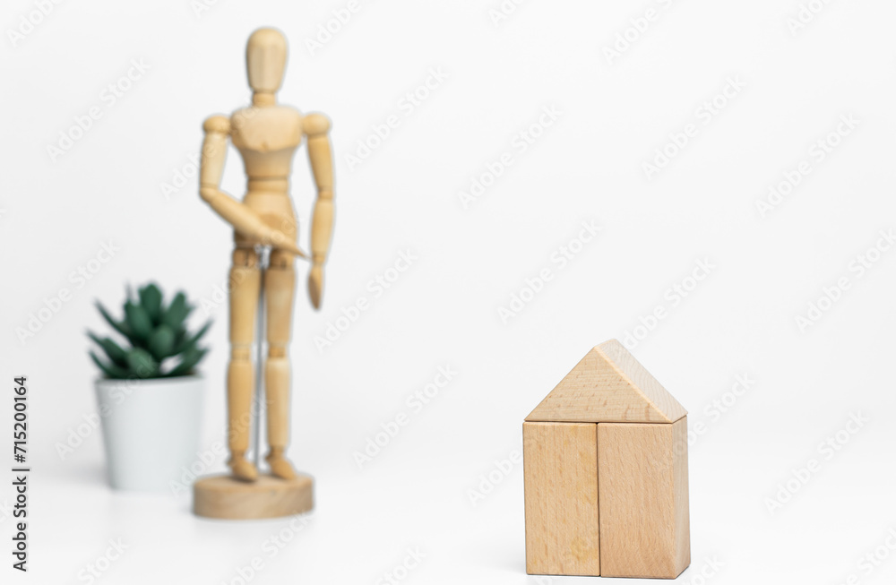Wooden doll with wooden toy block isolated on white background. business or creative concept Wooden doll with wooden toy block isolated on white background. business or creative concept