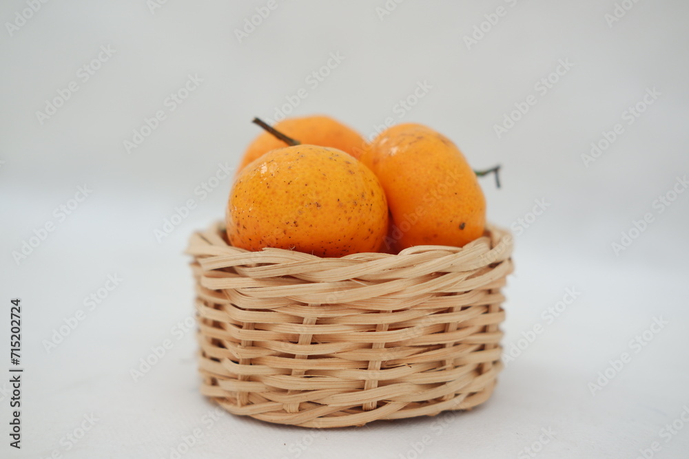 Fresh tangerines in a basket on white background, stock photo Fresh tangerines in a basket on white background, stock photo