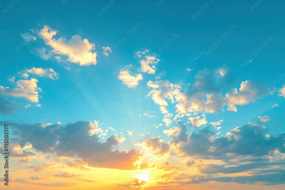 a sunset on a plain blue sky with clouds