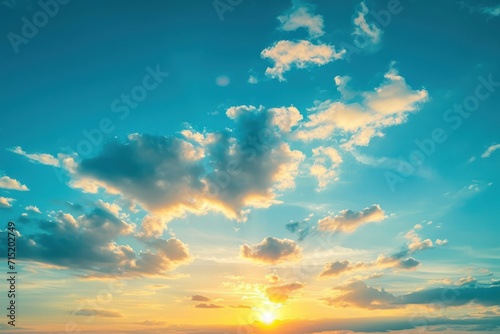 a sunset on a plain blue sky with clouds © Muh