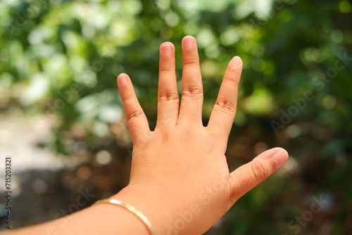 hand of a child on a green background. focus on the hand