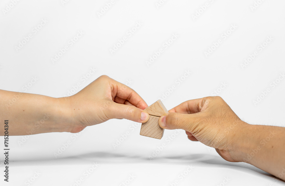 Two hands positioning wood blocks on white background. business or creative concept Two hands positioning wood blocks on white background. business or creative concept