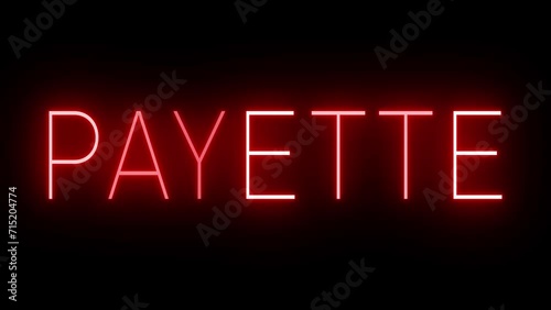Flickering red retro style neon sign glowing against a black background for PAYETTE photo