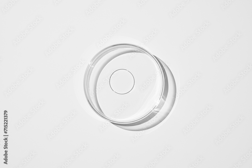 top view shot of a petri dish with liquid bubbles oil on a white background. hard lighting hard shadow. top view shot of a petri dish with liquid bubbles oil on a white background. hard lighting hard shadow.