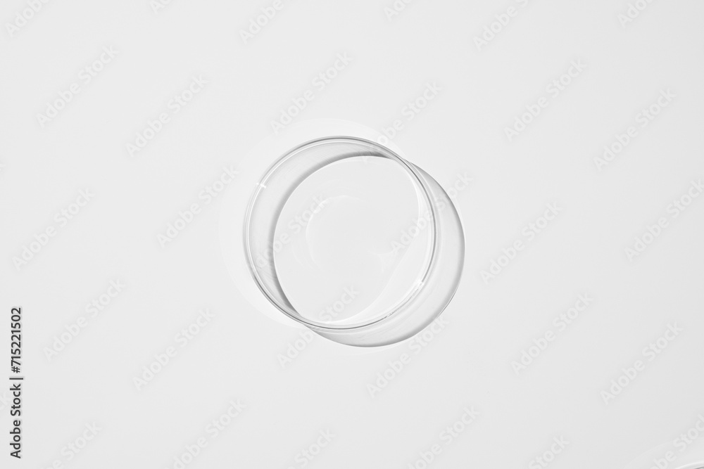 top view shot of a petri dish with liquid bubbles oil on a white background. hard lighting hard shadow. top view shot of a petri dish with liquid bubbles oil on a white background. hard lighting hard shadow.