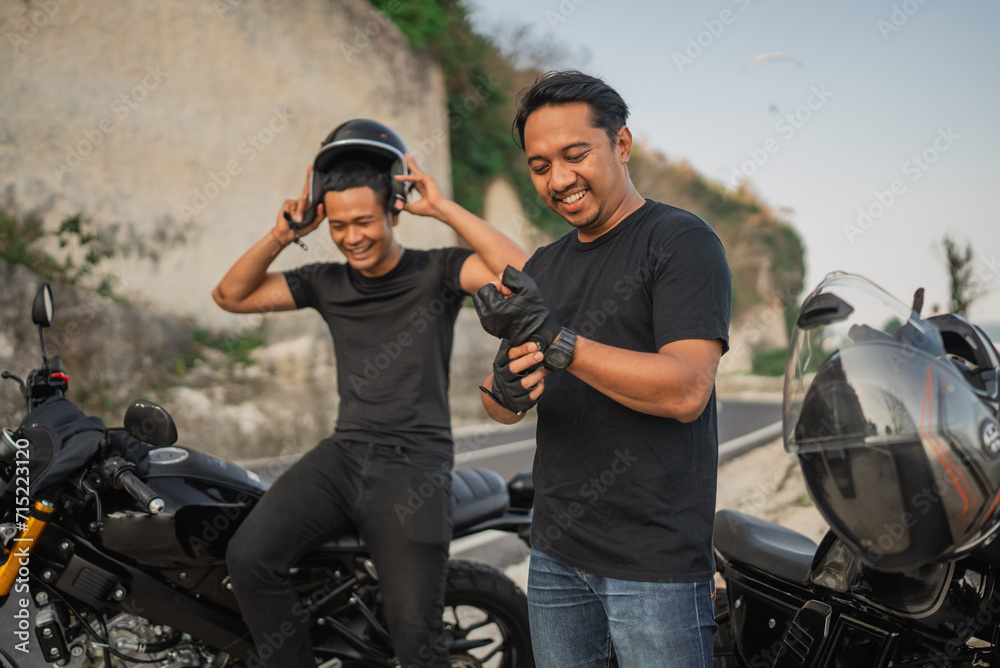 indonesian riders preparing riding motorbike wearing helmet and gloves