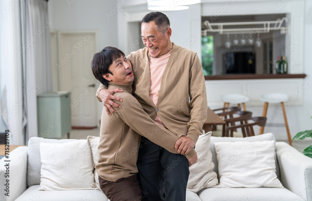 Portrait of enjoy happy love asian family senior mature father and young man son smiling play laughing and having fun together at home, care, elderly, insurance.happy family and Father Day concept.