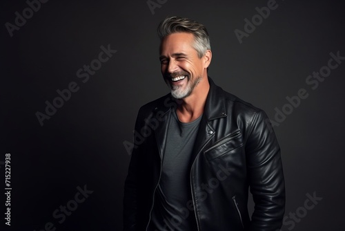 Portrait of a handsome mature man in a leather jacket. Men's beauty, fashion. © Inigo