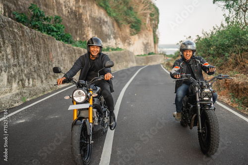indonesian men enjoying riding motorcycle outdoors, motorcycle adventure concept