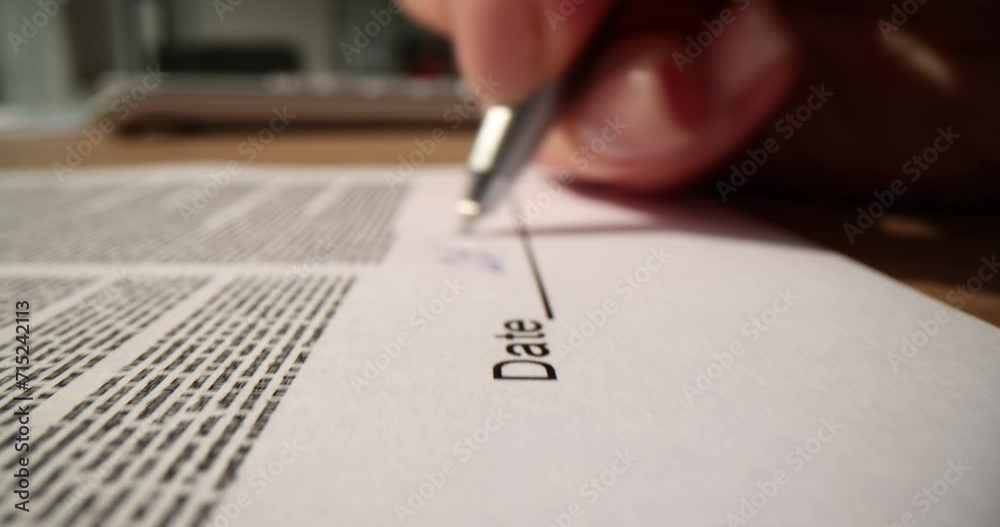 Closeup of woman hands signing contract and handwriting date