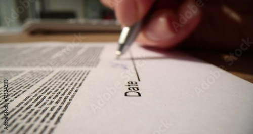 Closeup of woman hands signing contract and handwriting date