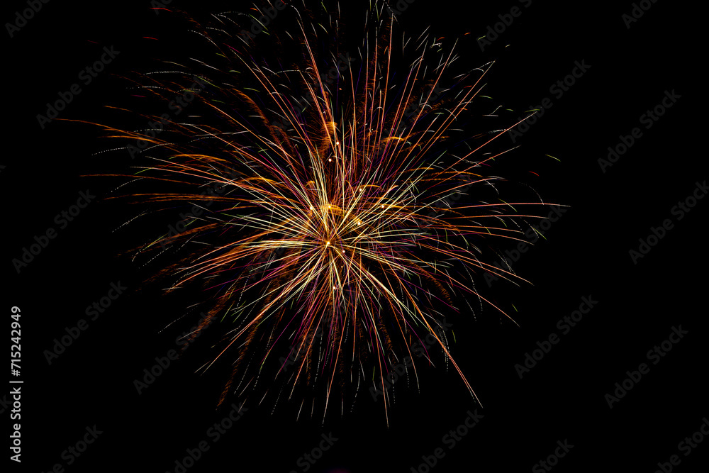 Fireworks. Colorful celebration fireworks isolated on a black sky background.Abstract and brightly colorful firework in the celebration and anniversary festival.New year party light over night sky.