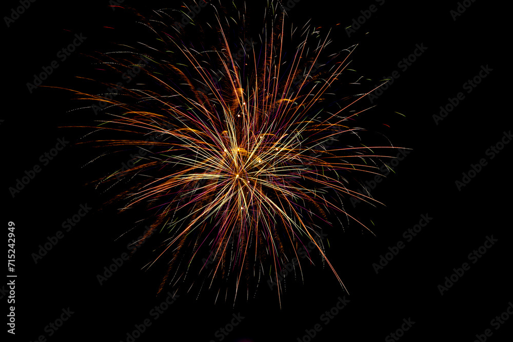Obraz premium Fireworks. Colorful celebration fireworks isolated on a black sky background.Abstract and brightly colorful firework in the celebration and anniversary festival.New year party light over night sky.