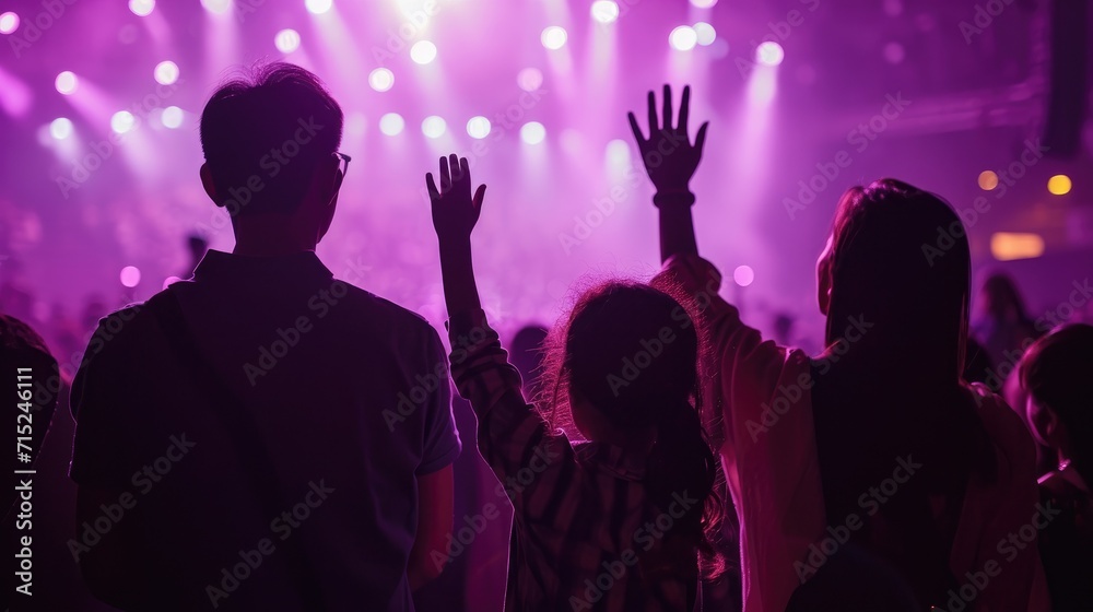 Christian family raised hands to praise God in church worship concert concept for religion, worship, prayer heaven after life