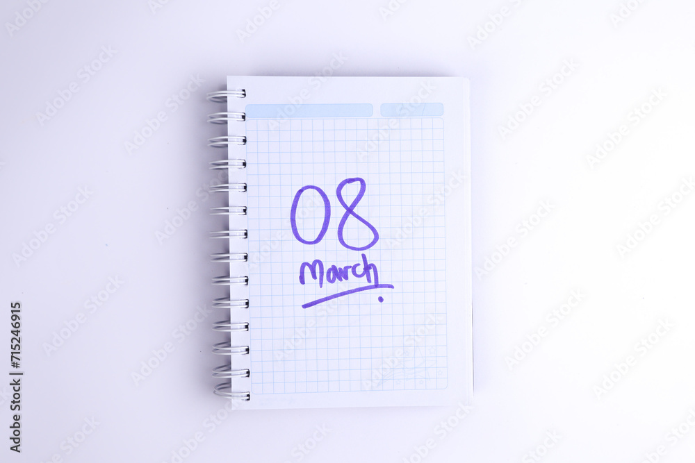 Notebook photo on a white background with hand drawn March 8 heart. Concept of people and lifestyles. Notebook photo on a white background with hand drawn March 8 heart. Concept of people and lifestyles.