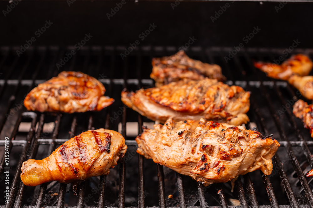 chicken cooking on barbecue flame grill

