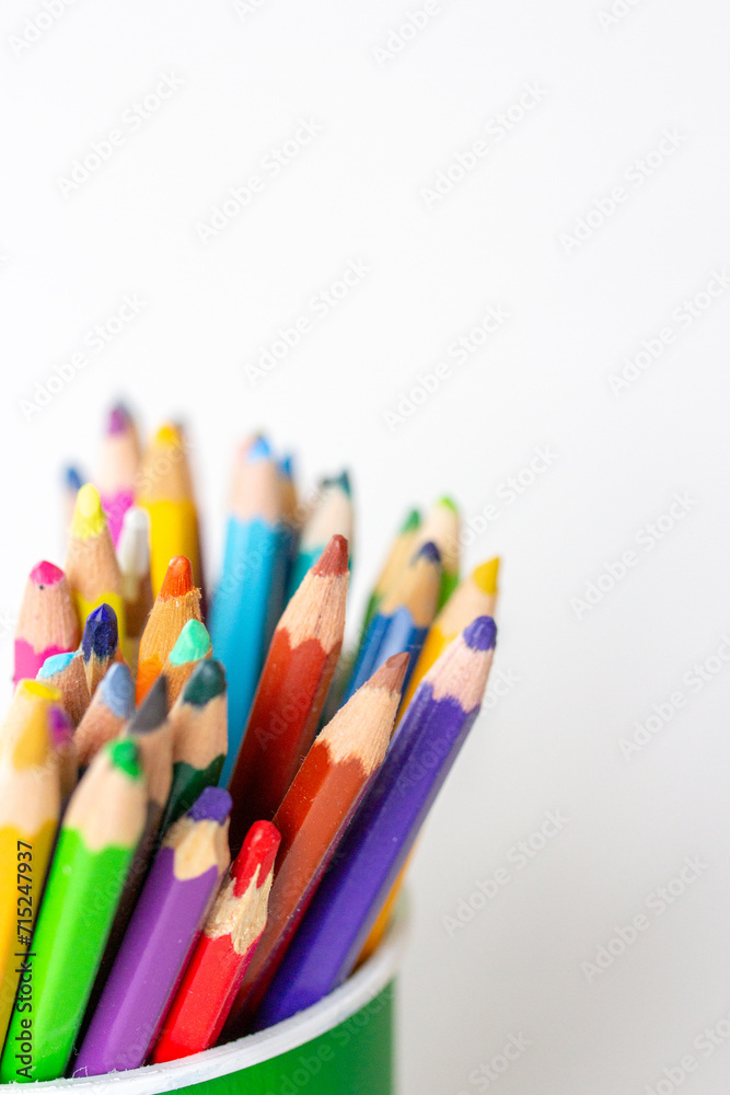 Colored pencils in green pencil case on white background, colorful tools for drawing and art hobby Colored pencils in green pencil case on white background, colorful tools for drawing and art hobby