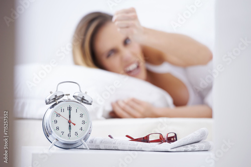 Sleeping, anger and woman in bed with alarm for snooze, wake up and morning routine in home. Lazy, tired and person frustrated, angry and upset in bedroom for time, clock and ringing in apartment