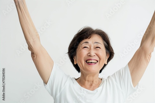 歓声をあげて応援する笑顔の日本人女性のおばあちゃん（白背景・オリンピック・日本代表・ワールドカップ・世界大会・Jリーグ・野球・スポーツ） photo