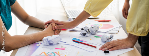 Panorama startup employee holding hand to stressed colleague due to failure, frustrated from no inspiration, lack of idea. Exhausted from overwhelm work and supportive coworker concept. Synergic photo