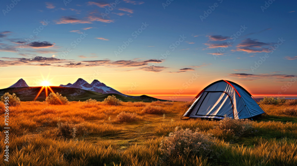 Tent in Field With Setting Sun. Hiking and outdoor recreation.