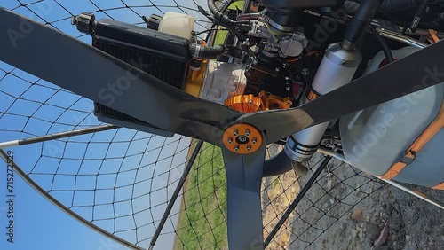 Vertical format: Closeup detail view of paramotor engine and propeller photo