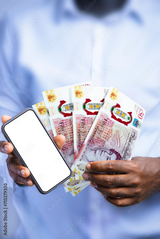 Black person holding British pound notes and showing mobile phone with blank screen to the camera. Hand holding English currency notes, 3d rendered money Black person holding British pound notes and showing mobile phone with blank screen to the camera. Hand holding English currency notes, 3d rendered money