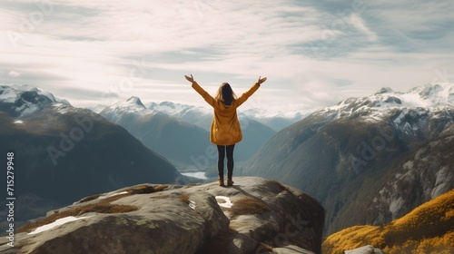 Woman with outstretched arms enjoying the beauty of the hills and mountains