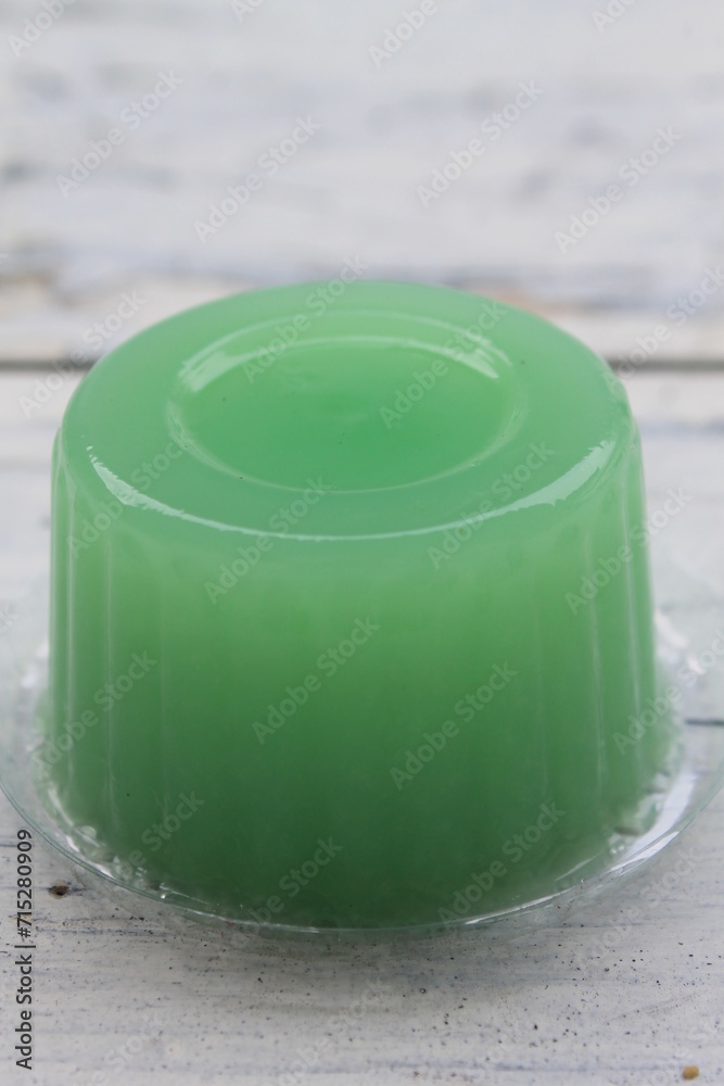 Green jelly in mica plastic on the table Green jelly in mica plastic on the table