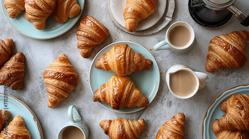 Create a scene of indulgence with an artfully arranged flat lay, featuring a variety of croissants, a French press, and elegant tableware – a feast for the eyes that celebrates the