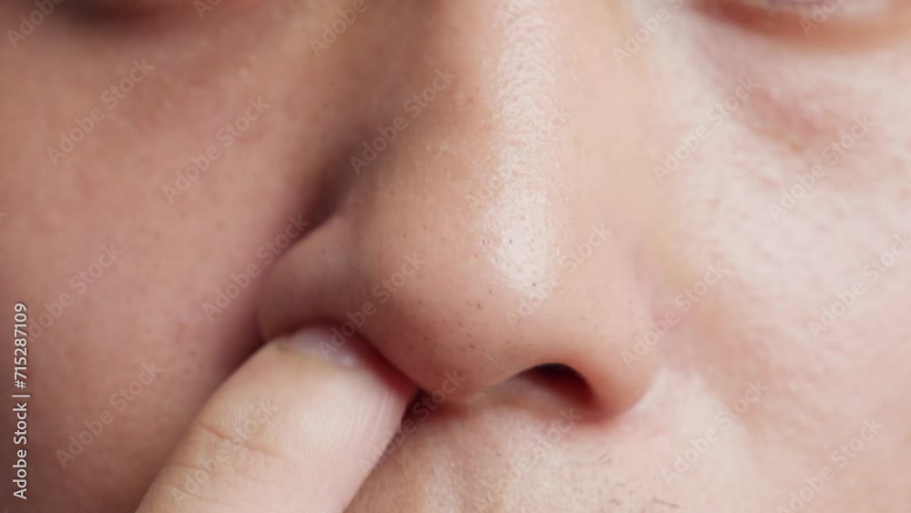 Close up of a young man picking nose with finger. Filthy habit. Close up of a young man picking nose with finger. Filthy habit.