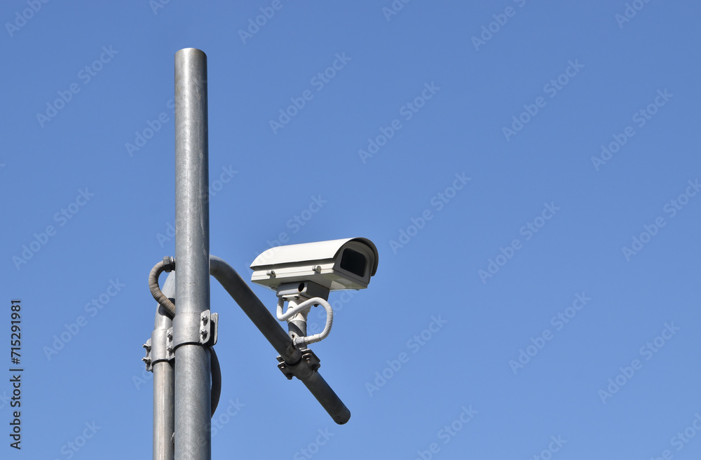 security cctv camera on grey steel post, surveillance camera with clear sky