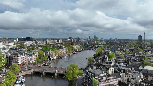 The drone is flying sideways rotating above the Amstel canal with a overview of the city Amsterdam in The Netherlands Aerial Footage 4K photo