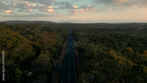 donre shot of a straight line road in the middle of the australian bush at sunset, south western highway between Manjimup and Walpole photo