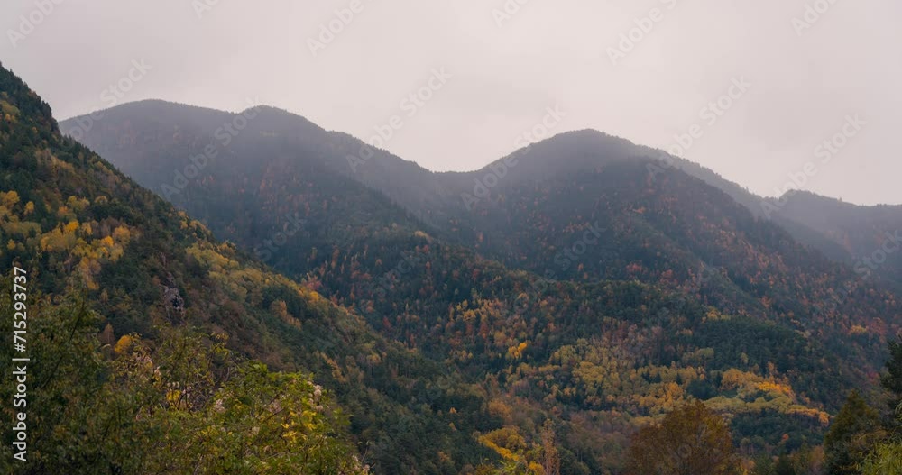 Close up detail timelapse Ordesa national park valley on a cloudy rainy and misty winter morning timelapse of clouds rolling over mountain peaks in fall autumn season Close up detail timelapse Ordesa national park valley on a cloudy rainy and misty winter morning timelapse of clouds rolling over mountain peaks in fall autumn season