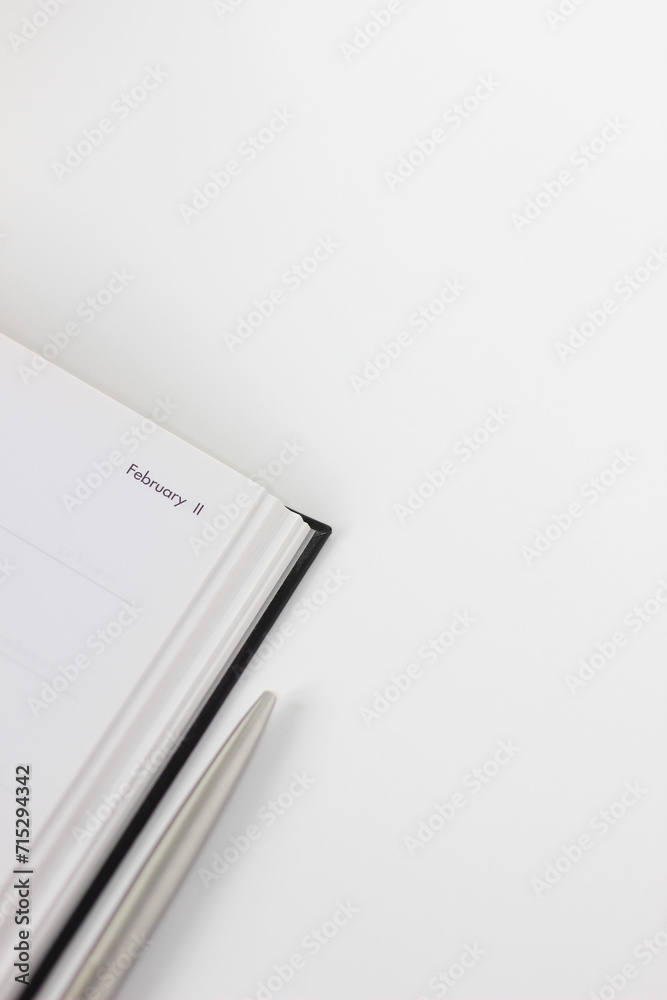 Notebook Planner for February on White Desk with Pen. Making Notes. Business Planning Mockup, Workplace Flatlay. Notebook Planner for February on White Desk with Pen. Making Notes. Business Planning Mockup, Workplace Flatlay.