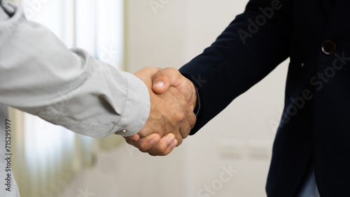 businessman making handshake to success deal to be partnership. Two business men agreement company trade partnership handshake, dealing, merger and acquisition, business partner joint venture concept.