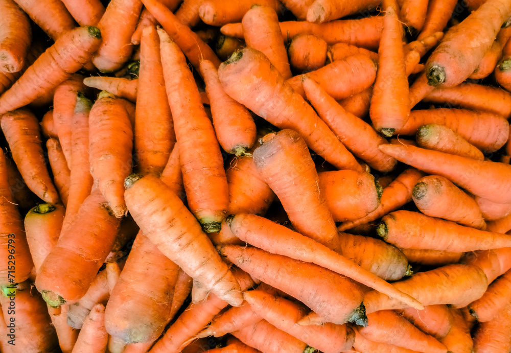 Bunch of fresh carrots on a market stall, top view. Bunch of fresh carrots on a market stall, top view.