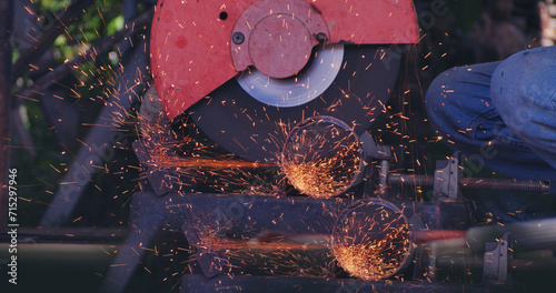 Hot flame welding metal work cutting fire iron workshop. Welding machine iron metal sparking. Locksmith using Welding machine cutting metal processing grinder. Close up hands Sparks in metalworking