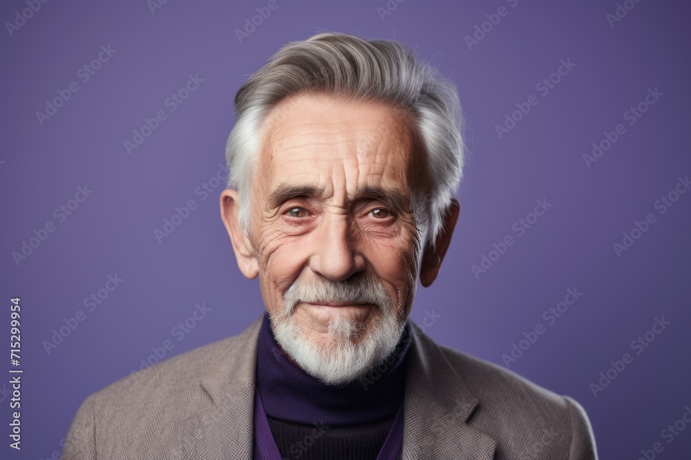 Portrait of a senior man with grey hair and beard on a purple background Portrait of a senior man with grey hair and beard on a purple background