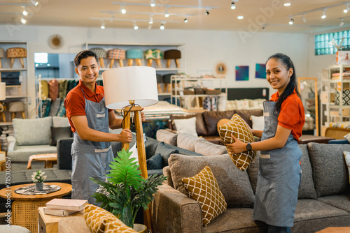 Wallpaper Mural shop assistants in apron with their friend working to tidy up the furniture store Torontodigital.ca