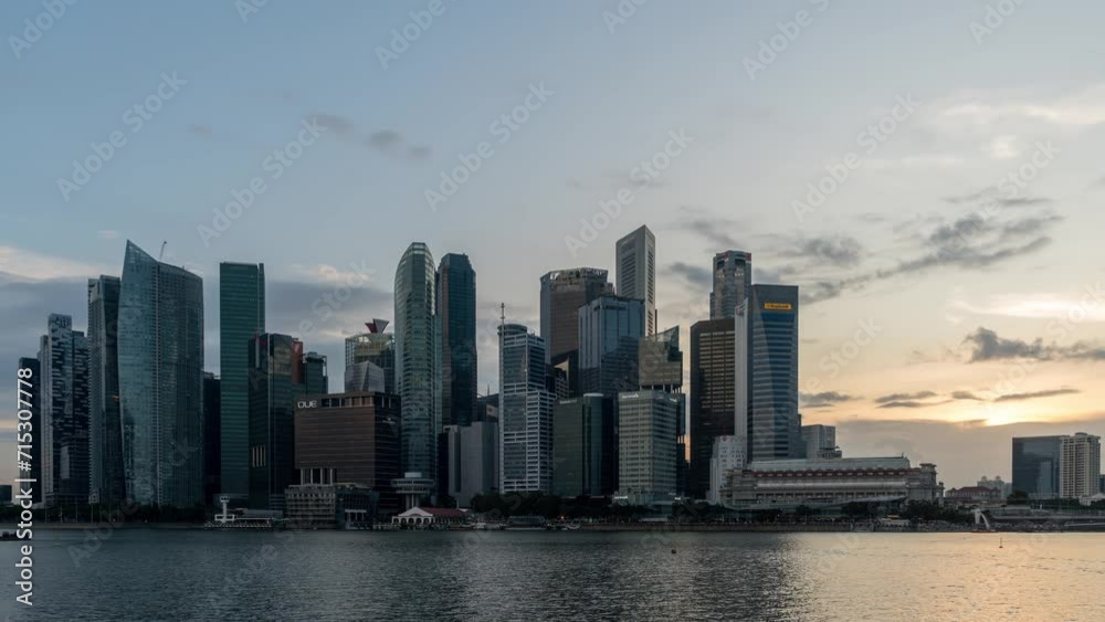 Timelapse Day to Night of Singapore City Skyline and Financial district across Marina Bay under a beautiful sky and light in Singapore. Time lapse Day to Night City. Timelapse Day to Night of Singapore City Skyline and Financial district across Marina Bay under a beautiful sky and light in Singapore. Time lapse Day to Night City.