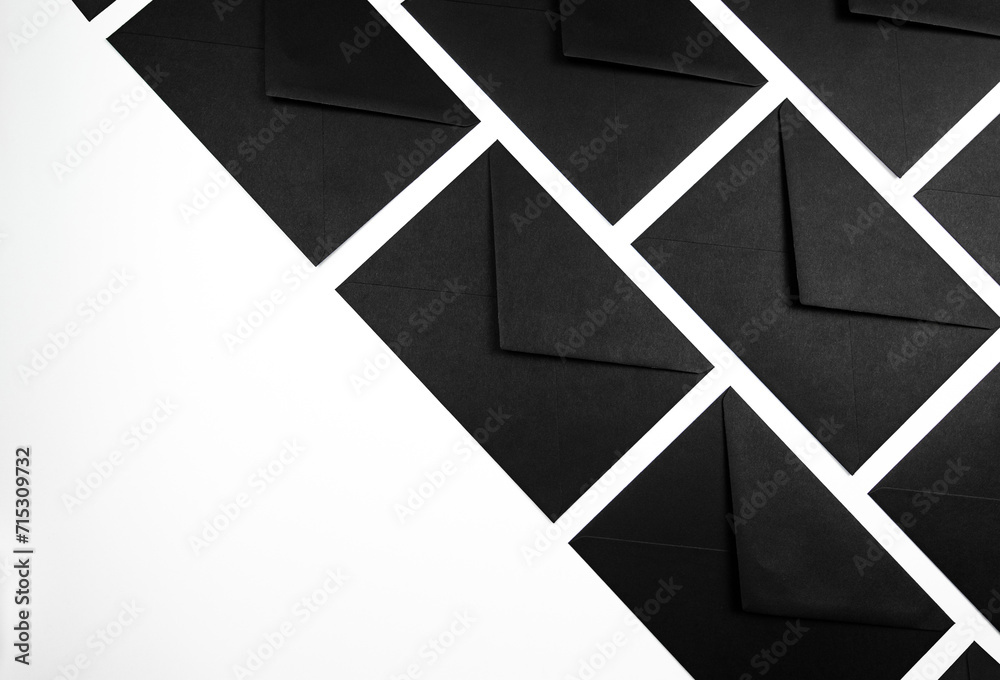Top view of black envelopes on white background. Post flat lay. Copy space. Top view of black envelopes on white background. Post flat lay. Copy space.